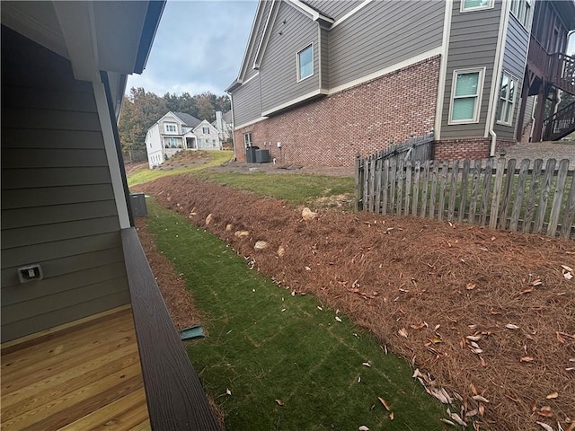 view of side of home with central AC unit