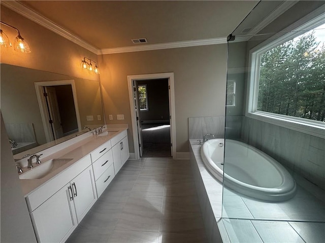 bathroom with vanity, a relaxing tiled tub, tile patterned floors, and crown molding