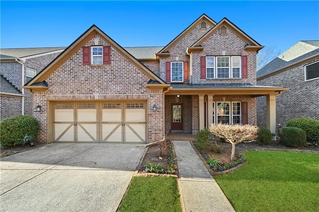 craftsman-style house featuring a garage, driveway, brick siding, and a front lawn