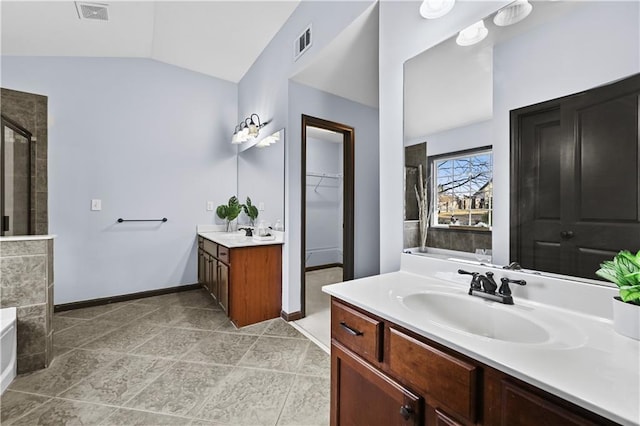 full bath featuring a sink, visible vents, vaulted ceiling, a shower stall, and a bath