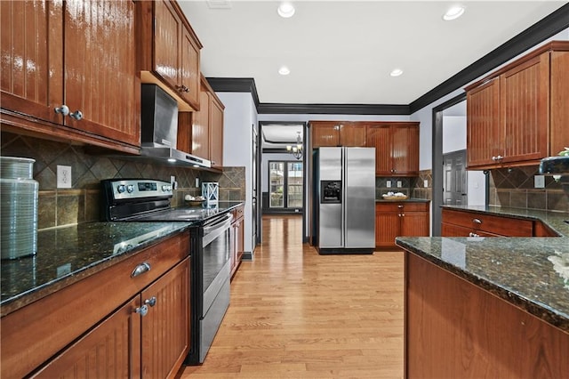 kitchen featuring wall chimney exhaust hood, appliances with stainless steel finishes, light wood-type flooring, and crown molding