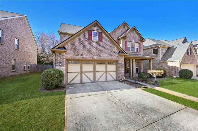 view of front of home with driveway, fence, a front lawn, and brick siding