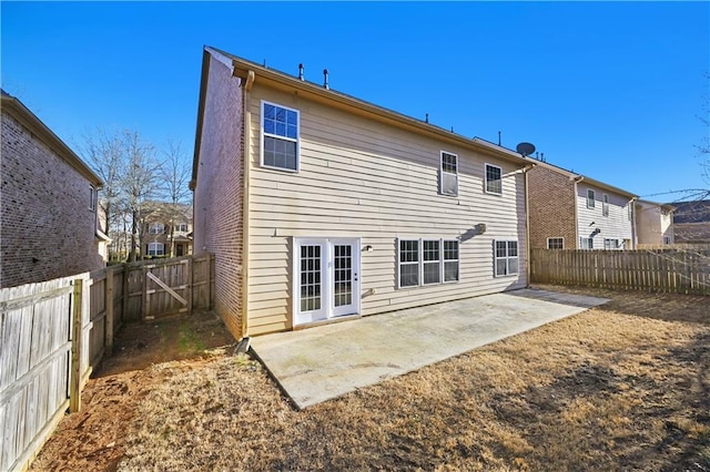 back of house featuring a patio area, brick siding, and a fenced backyard