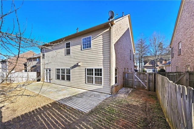 back of house featuring a patio area and a fenced backyard