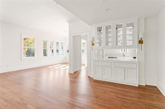 1585 S Ponce De Leon Ave NE Unit 20, Atlanta, GA 30307 - bar featuring plenty of natural light, wood finished floors, baseboards, and crown molding