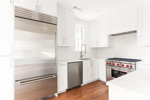 1585 S Ponce De Leon Ave NE Unit 20, Atlanta, GA 30307 - kitchen with premium appliances, a sink, and white cabinets