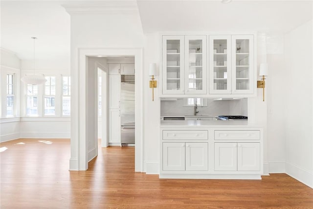 1585 S Ponce De Leon Ave NE Unit 20, Atlanta, GA 30307 - bar featuring stainless steel built in fridge, light wood-type flooring, baseboards, and decorative light fixtures