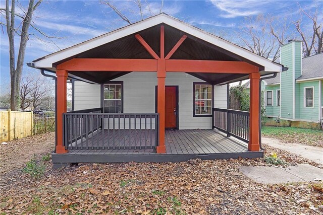 rear view of house featuring a porch