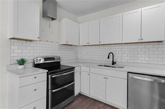 kitchen featuring tasteful backsplash, sink, white cabinets, and appliances with stainless steel finishes