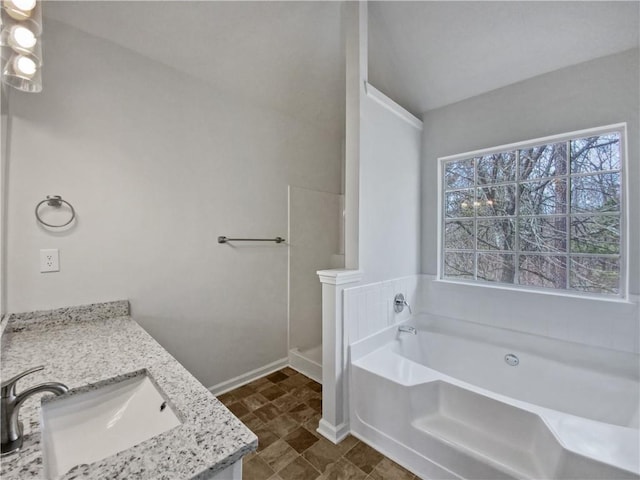 bathroom featuring a tub and vanity