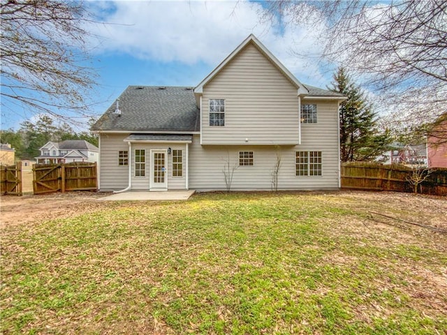 rear view of house with a lawn and a patio area