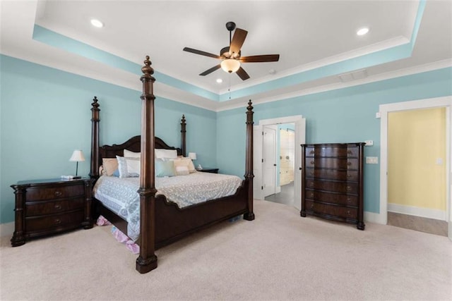 carpeted bedroom with recessed lighting and a raised ceiling