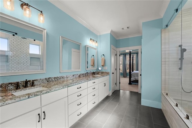 bathroom featuring double vanity, visible vents, tiled shower, crown molding, and a sink