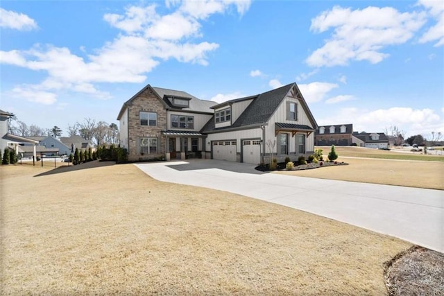 view of front of property featuring a standing seam roof, metal roof, a garage, stone siding, and driveway