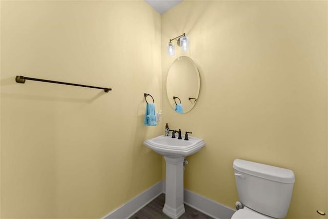 bathroom with toilet and baseboards