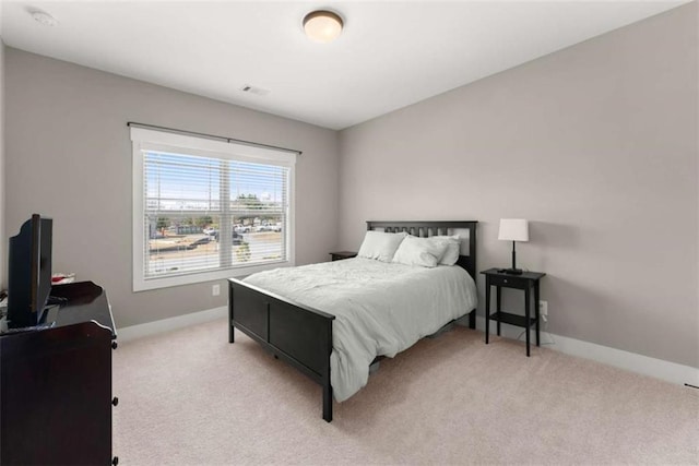 bedroom with carpet flooring, visible vents, and baseboards