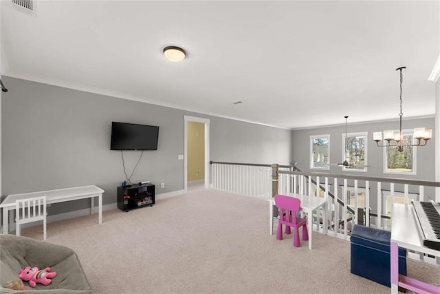 recreation room featuring baseboards, visible vents, ornamental molding, carpet flooring, and a chandelier