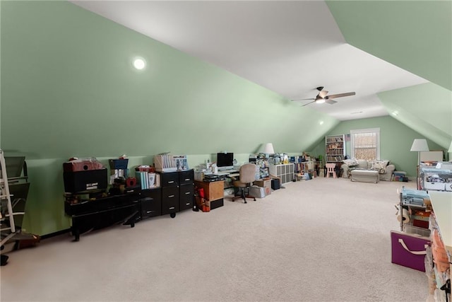 carpeted office with vaulted ceiling and a ceiling fan