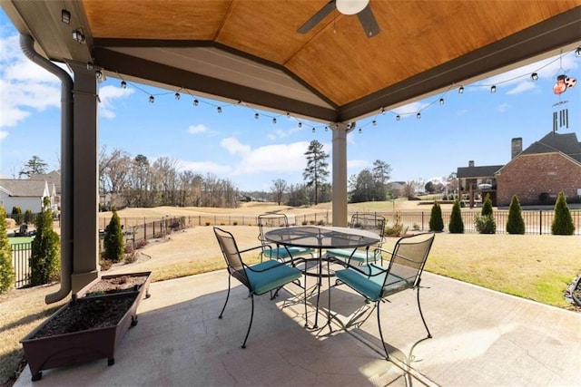 view of patio featuring a ceiling fan, outdoor dining area, and a fenced backyard