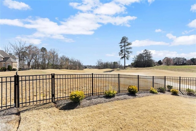 view of yard featuring a rural view and fence