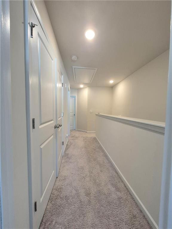 hallway featuring light colored carpet