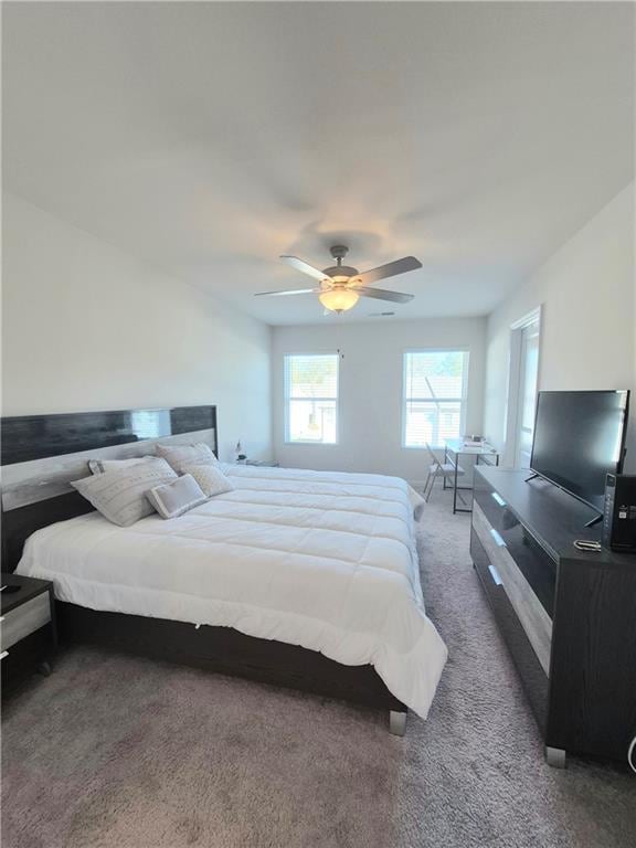 bedroom with dark carpet and ceiling fan