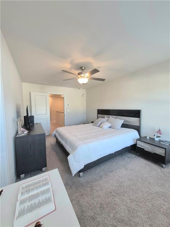 bedroom with dark colored carpet and ceiling fan