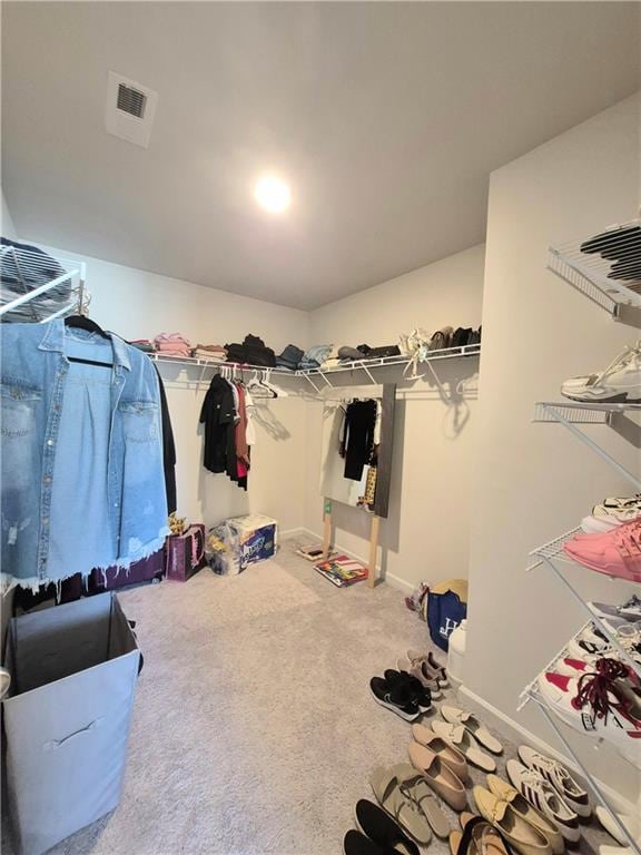 walk in closet featuring carpet