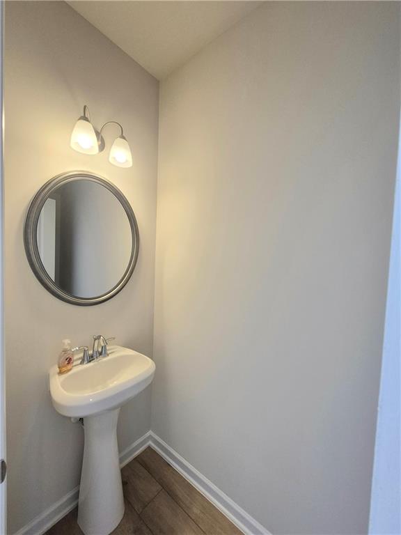 bathroom with hardwood / wood-style flooring