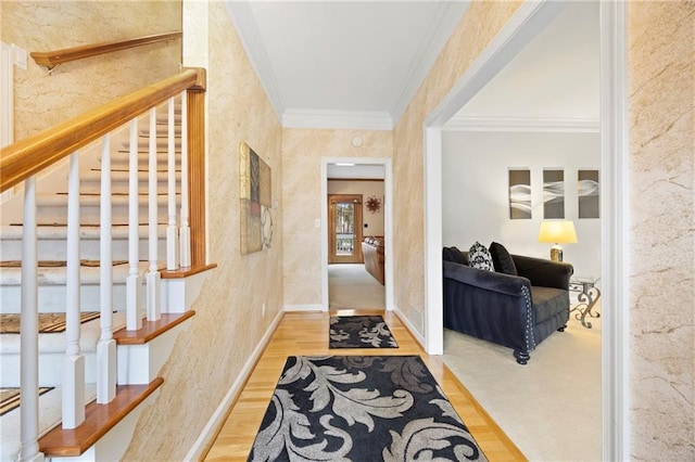 hallway featuring crown molding, stairway, baseboards, and wood finished floors