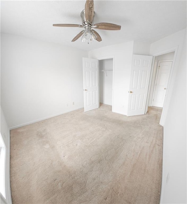 unfurnished bedroom featuring light carpet, ceiling fan, and a closet