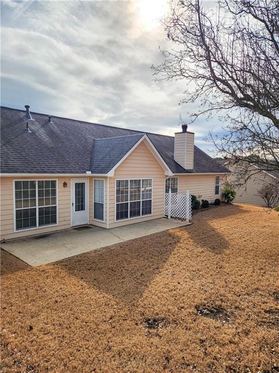 rear view of property featuring a patio area