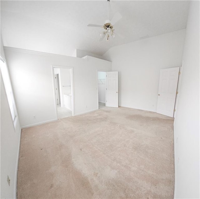 carpeted spare room with lofted ceiling and ceiling fan