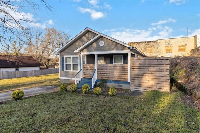 view of front of house featuring crawl space, entry steps, a front yard, and fence