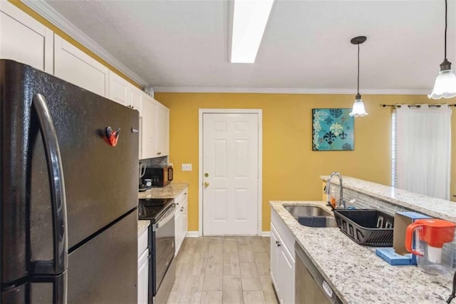 kitchen with white cabinets, ornamental molding, appliances with stainless steel finishes, and a sink