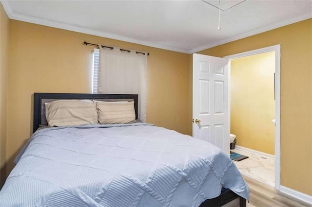 bedroom featuring attic access, wood finished floors, crown molding, and baseboards