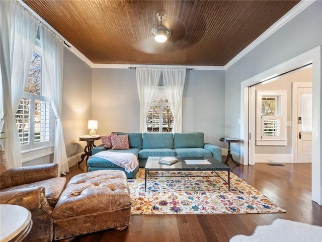 living room featuring a wealth of natural light, crown molding, and hardwood / wood-style flooring