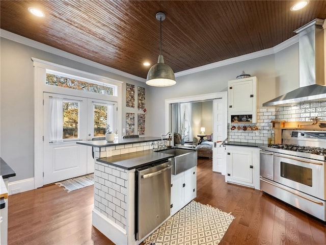 kitchen with white cabinetry, sink, stainless steel appliances, and decorative light fixtures