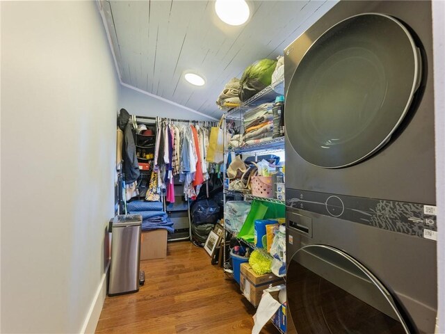 storage area featuring stacked washing maching and dryer