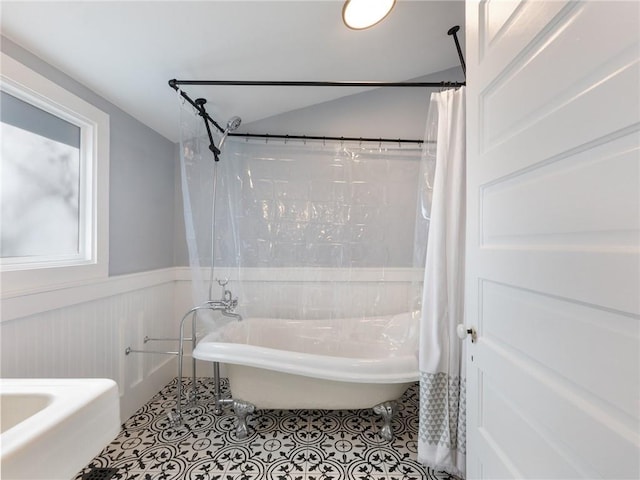 bathroom with tile patterned flooring and shower / tub combo with curtain