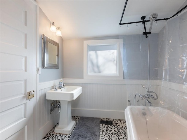 bathroom featuring tile patterned floors, lofted ceiling, and tiled shower / bath