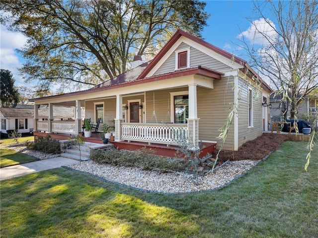 farmhouse with covered porch and a front yard