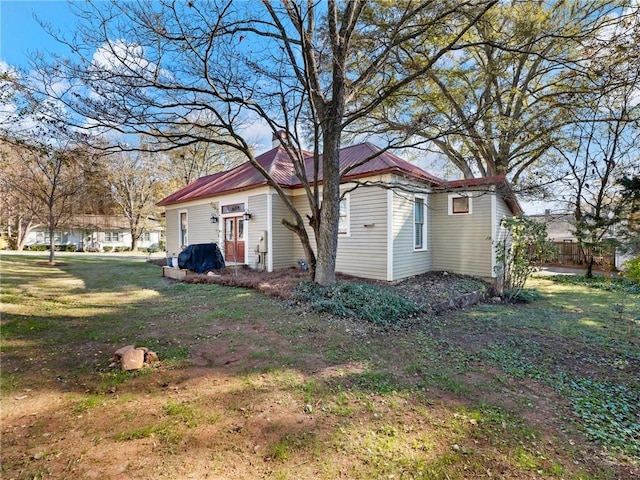 view of side of home featuring a yard