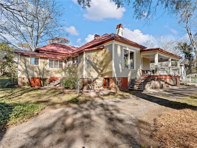 rear view of property featuring a porch