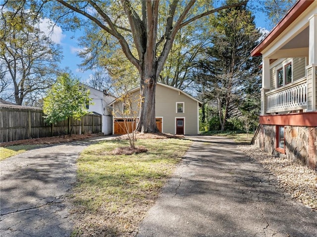 view of side of home featuring a storage shed