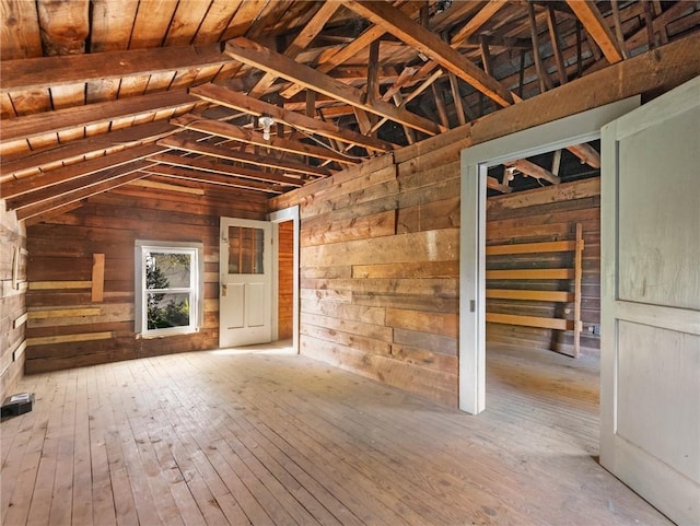 interior space featuring wooden ceiling, hardwood / wood-style flooring, vaulted ceiling, and wooden walls