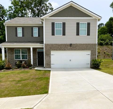 249 Creekview Way, Dallas, GA 30132 - view of front facade featuring a garage, brick siding, a front yard, and concrete driveway