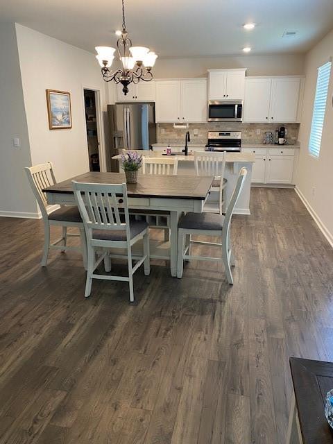 249 Creekview Way, Dallas, GA 30132 - dining space with a chandelier, dark wood-style flooring, baseboards, and recessed lighting