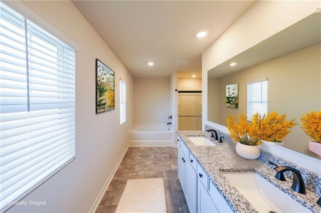 249 Creekview Way, Dallas, GA 30132 - full bath featuring baseboards, plenty of natural light, stone finish flooring, a bath, and recessed lighting
