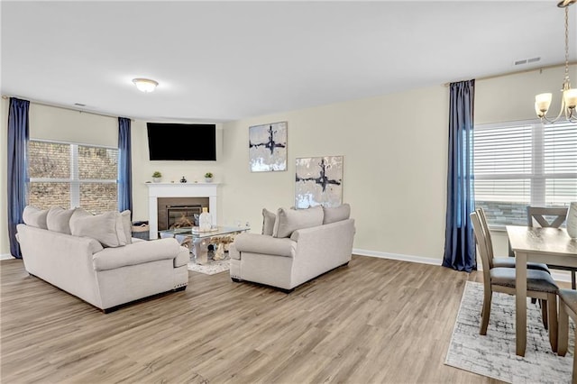 living room featuring hardwood / wood-style floors and an inviting chandelier